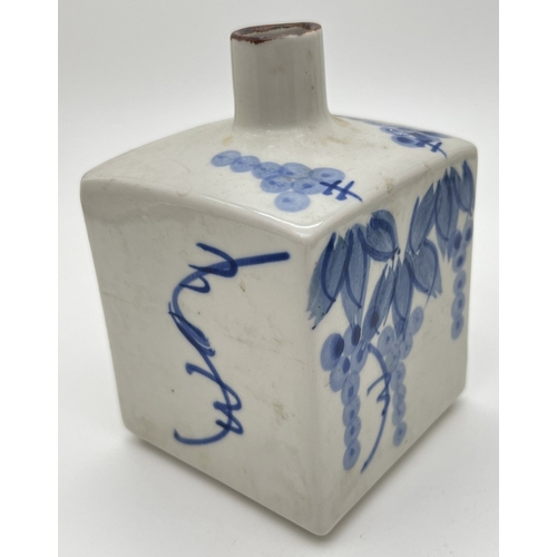 1263 - A small blue and white glazed Oriental square shaped vase with floral decoration. Approx. 13cm tall.