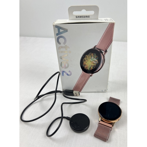 1135 - A boxed Samsung Galaxy Active 2 watch. Gold tone stainless steel case with replacement pink mesh str... 