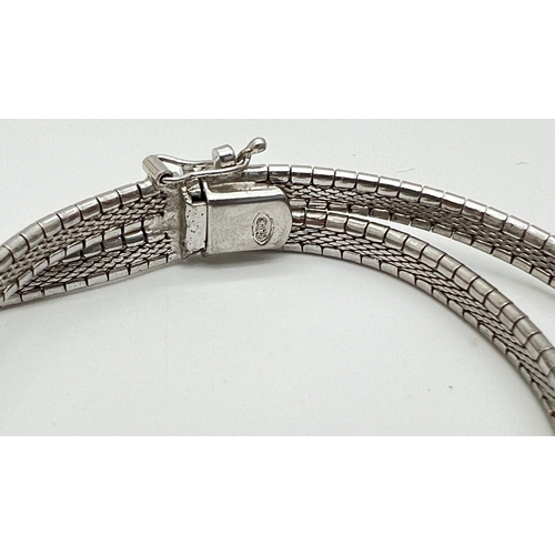 1085 - 2 silver bracelets. An 800 brushed silver double strand chain bracelet with push clasp and safety cl... 