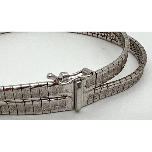 1085 - 2 silver bracelets. An 800 brushed silver double strand chain bracelet with push clasp and safety cl... 