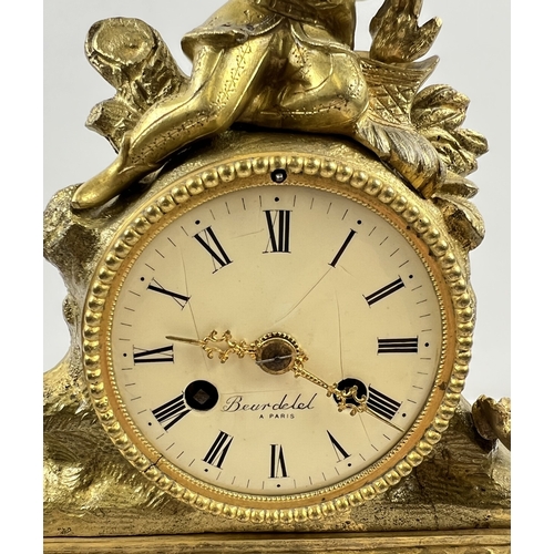 1240 - A vintage ornate brass striking mantle clock in a Rococo style with figure of a boy to top. Enamel f... 