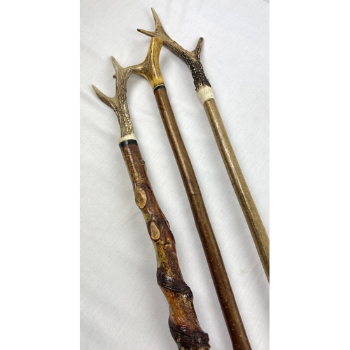 1321 - 3 vintage rustic thumb sticks with deer antler handles. Tallest approx. 131cm.