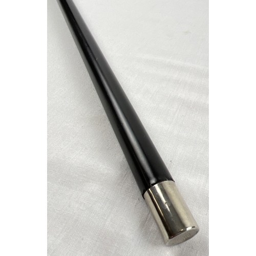 1169 - A vintage silver crook handled ebonised walking cane with embossed pattern to handled, stamped 925. ... 