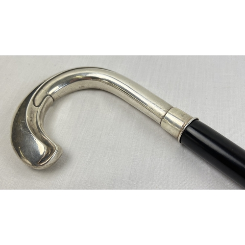 1169 - A vintage silver crook handled ebonised walking cane with embossed pattern to handled, stamped 925. ... 