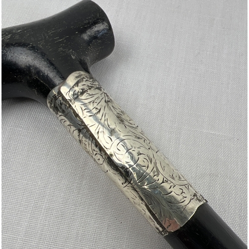 1170 - An Edwardian ebonised walking cane with hallmarked silver collar engraved 'T. H. Bottomley' and with... 