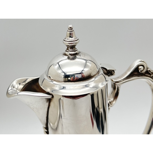 1180 - An Elizabeth II silver mounted clear glass claret jug with decorative handle, hinged lid and turned ... 