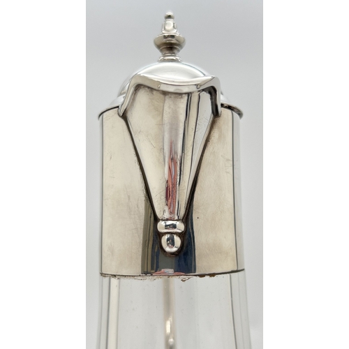 1180 - An Elizabeth II silver mounted clear glass claret jug with decorative handle, hinged lid and turned ... 