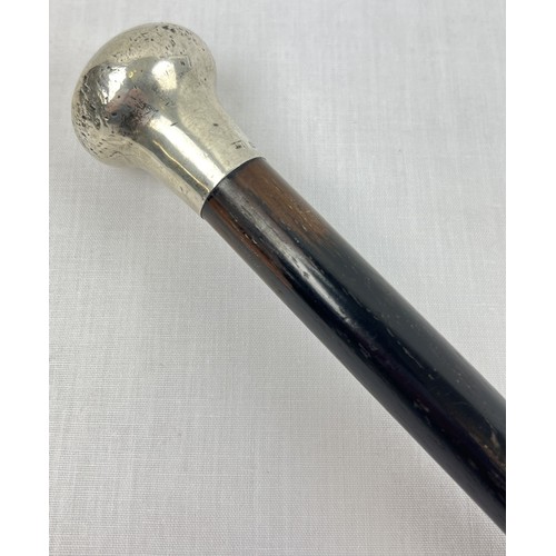 1172 - An antique ebonised walking cane with hallmarked silver pommel top. Assay mark for London, date lett... 