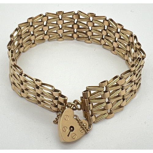 A vintage 9ct gold 4 bar gate bracelet with heart shaped padlock clasp and safety chain. Fully hallmarked to back of padlock. Approx. 2cm band width and 6cm diameter. Total weight approx. 20.3g.