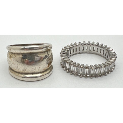 1043 - 2 silver rings. A full eternity style ring set with baguette cut clear stones and stamped S925 insid... 