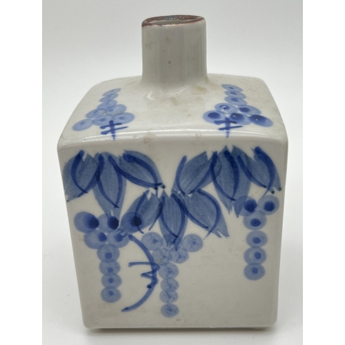 1263 - A small blue and white glazed Oriental square shaped vase with floral decoration. Approx. 13cm tall.