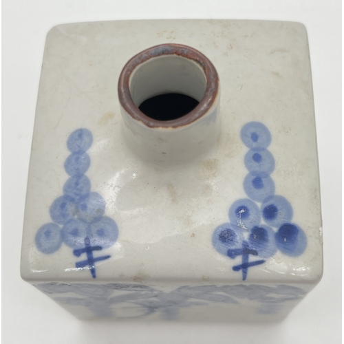 1263 - A small blue and white glazed Oriental square shaped vase with floral decoration. Approx. 13cm tall.