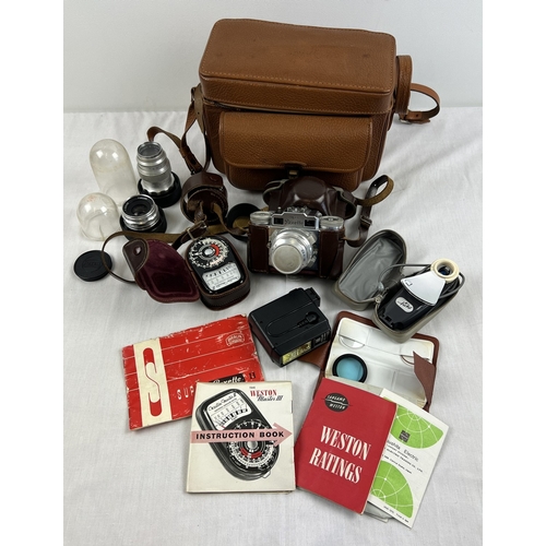 1285 - A vintage Braun Super Paxette camera with extra lens and accessories and instruction booklets, in br... 