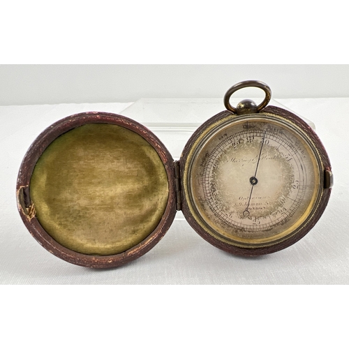 1300 - An antique pocket barometer, Murray and Heath Opticians, Jermyn St, London. In original maroon leath... 