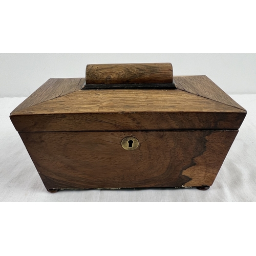 1315 - A vintage rosewood sarcophagus shaped tea caddy with small bun feet and brass key escutcheon. Two li... 