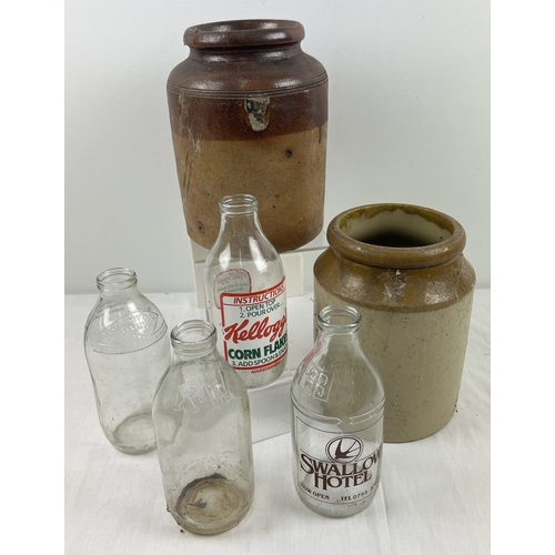 1273 - 2 vintage stoneware jars together with 4 vintage glass 1 pint milk bottles to include advertising. M... 