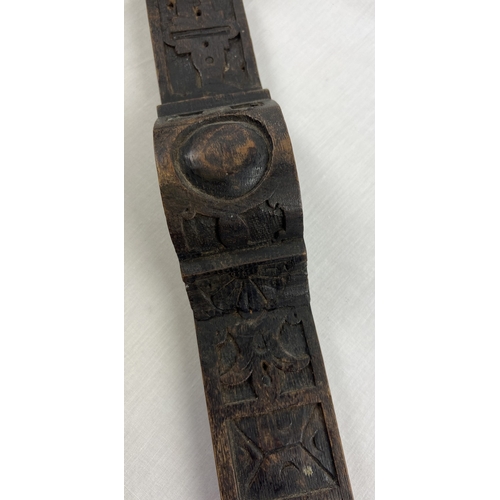 1343 - An antique carved dark wood piece of moulding, approx. 98cm long.