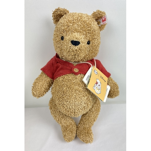 A Steiff 2021 Disney Winnie the Pooh jointed Bear, 95th anniversary edition. No. 1051/1926. Button to left ear made with a sustainable paper plush finish. Complete with original box and certificate. Bear approx. 30cm tall.