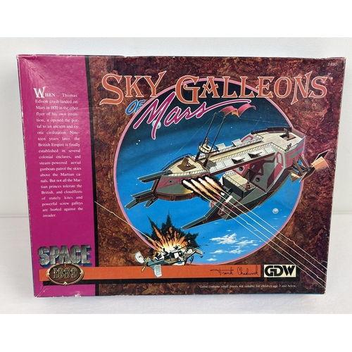 Space 1889 Sky Galleons of Mars - science fiction strategy game from Game Designers' Workshop (GDW), 1988. Missing the original ship models, but otherwise complete. Comes with Space 1889 Adversaries plastic Martian Skyships, also from GDW (1989). Box has some slight scuffing, otherwise all in very good condition.