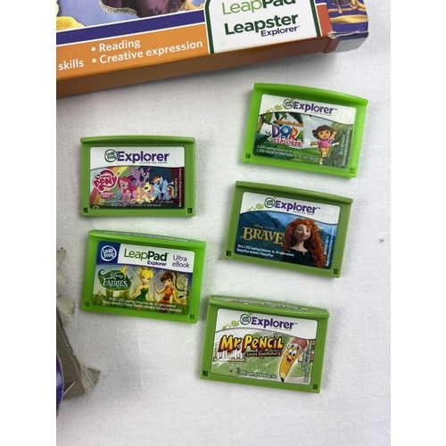 12 - Leapfrog Leap Pad console in pink, with assorted games and accessories. Comes with charger, pen, pur... 