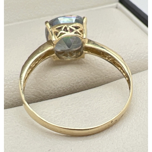 1001 - A 9ct gold and mystic topaz ring with large cushion cut stone and engraved detail to shoulders. Stam... 