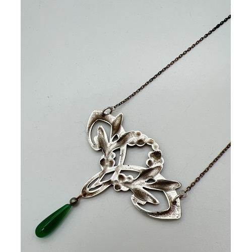 1008 - An Art Nouveau style fixed pendant necklace with enamelled leaf & berry design and green glass drop.... 