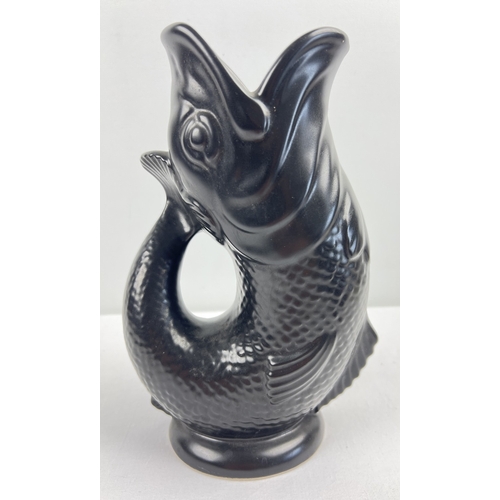 1270 - A vintage Dartmouth Pottery Gluggle fish vase/jug in matt black finish. Approx. 24cm tall.