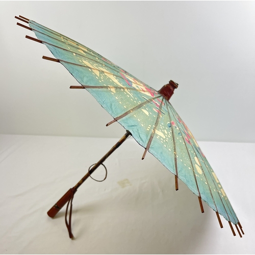 1290 - A vintage hand made paper parasol with turned wooden handle and leather straps.