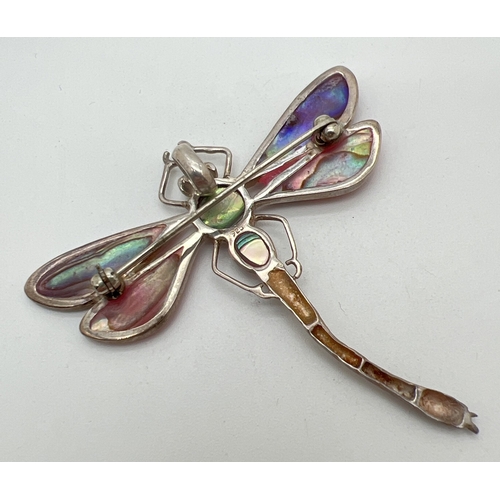 1032 - A large silver dragonfly pendant brooch. Wings and body set with pink dyed abalone shell. Silver mar... 