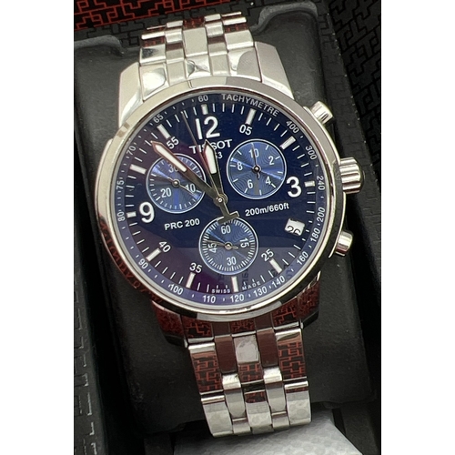 A boxed T-Sport PRC Chronograph wristwatch by Tissot. Stainless steel strap and case with blue face and secondary dials. Silver tone hands and hour markers with luminous detail. Water resistant 200 metres. In working order, box contains original warranty card.
