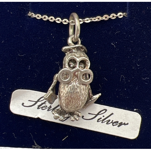 1045 - 2 boxed silver pendant necklaces. An unmarked white metal wise owl pendant with moving wings & eyes,... 