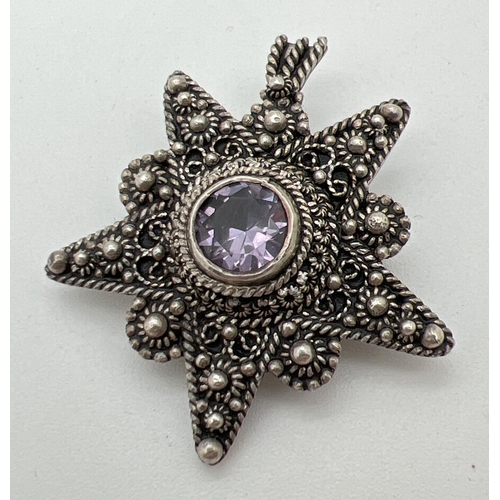 1046 - A Jerusalem silver decorative star shaped pendant brooch set with central round cut amethyst. Stampe... 