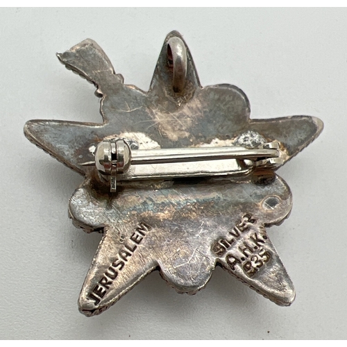 1046 - A Jerusalem silver decorative star shaped pendant brooch set with central round cut amethyst. Stampe... 