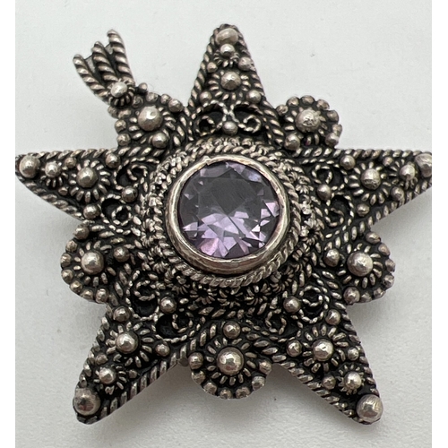 1046 - A Jerusalem silver decorative star shaped pendant brooch set with central round cut amethyst. Stampe... 