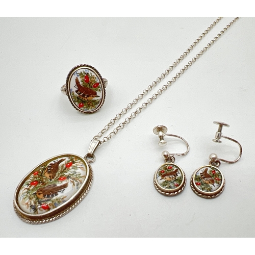 1064 - A silver pendant necklace with matching screw back earrings and ring. All set with ovals of ceramic ... 