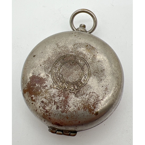 1310 - A vintage metal cased compass with wreath decoration to top of case. Approx. 4.5cm diameter.