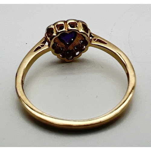 1011 - A 9ct gold heart shaped amethyst and diamond ring. Central amethyst haloed by 11 small round cut dia... 