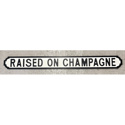 1331 - A modern painted wood 'Raised on Champagne' sign, in the style of an old street sign. Approx. 125cm ... 