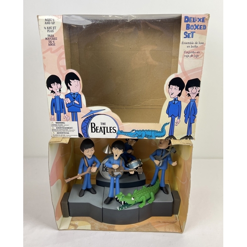 143 - A Deluxe Boxed Set The Beatles by McFarlane Toys. Characters are based on the 1965 animated TV serie... 