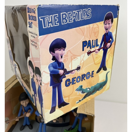 143 - A Deluxe Boxed Set The Beatles by McFarlane Toys. Characters are based on the 1965 animated TV serie... 