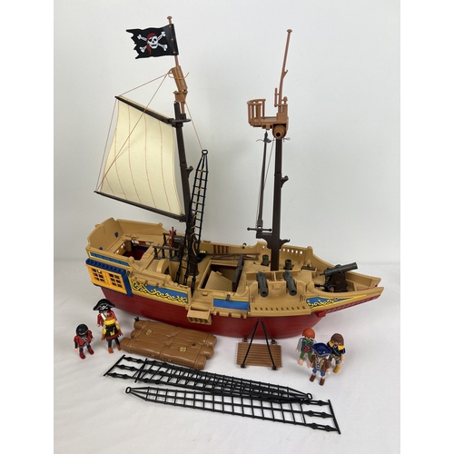 162 - A vintage Playmobile Pirate Ship with figures and accessories to include raft, cannons, furniture an... 