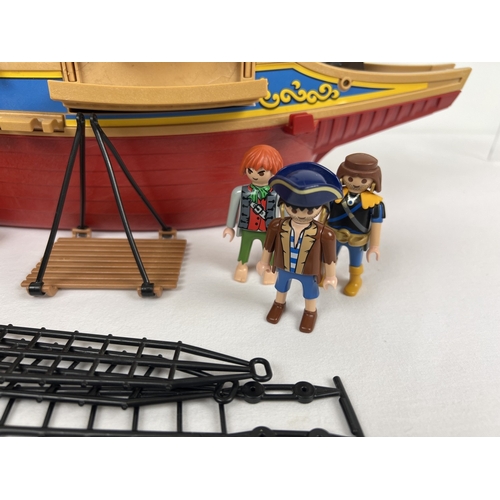 162 - A vintage Playmobile Pirate Ship with figures and accessories to include raft, cannons, furniture an... 