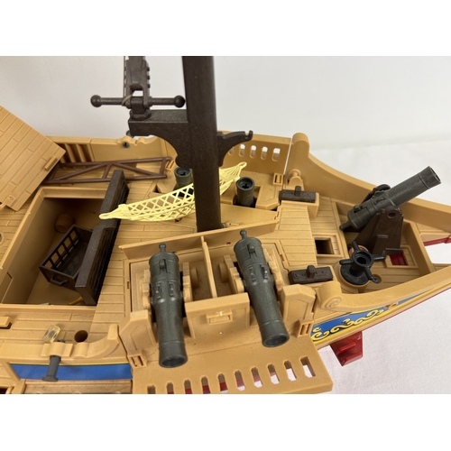 162 - A vintage Playmobile Pirate Ship with figures and accessories to include raft, cannons, furniture an... 