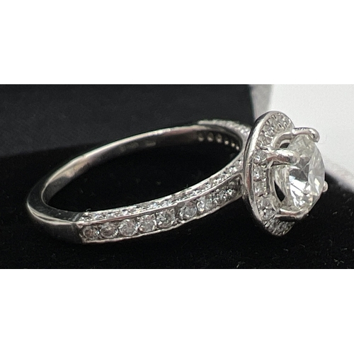 1042 - A platinum and diamond halo cluster ring with Central 0.82ct diamond. 3 rows of smaller diamonds to ... 