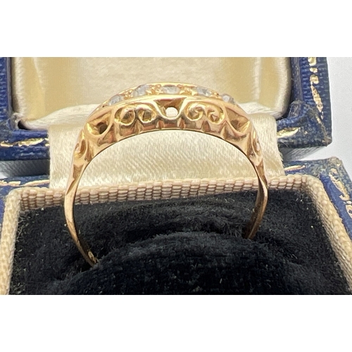 1079 - A vintage 9ct gold 5 stone diamond ring with decorative pierced design mount. Hallmark inside band i... 