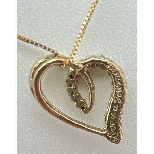 1092 - A boxed 9ct gold, diamond set (one missing) open heart pendant, on an 18