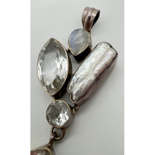 1142 - A large modern design silver pendant set with clear quartz, moonstone and a Keshi pearl. A marquise,... 