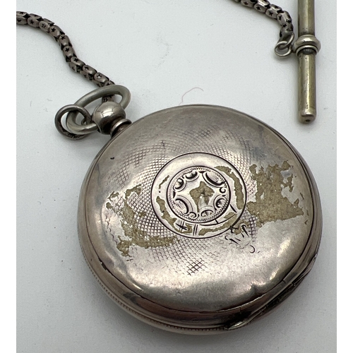 1181 - A Victorian silver cased pocket watch with white metal chain and albert. Engine turned decoration to... 