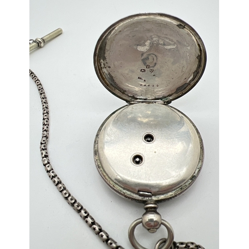 1181 - A Victorian silver cased pocket watch with white metal chain and albert. Engine turned decoration to... 