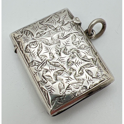 1210 - A Victorian silver vesta case with hanging ring and ivy leaf decoration to both front and back. Shie... 